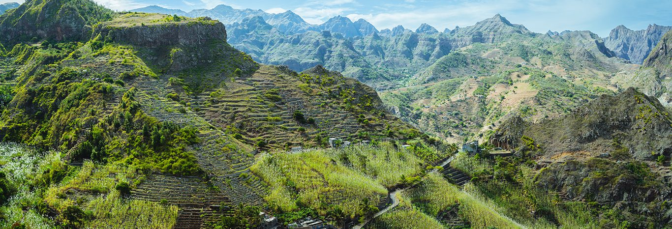 Cape Verde. Gorgeous panoramic view of famous fertile Paul Valley. Agriculture terraces of sugarcane in vertical valley sides, people dwellings, rugged peaks and motion clouds on horizon