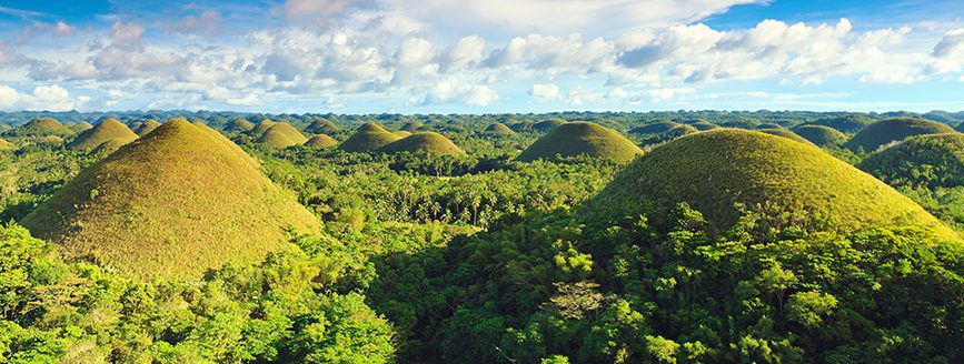 Chocolate Hills under blue sky in the Philippines.